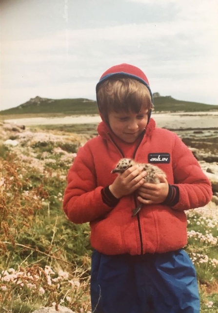 Matt Slater as a child holding a baby seagull on Tean, Isles of Scilly