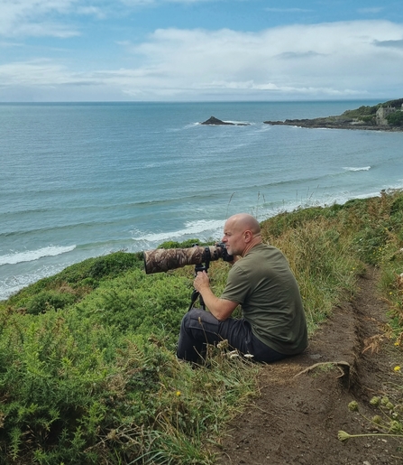 Andy on the day he took the photograph at Keneggy Cove, sat behind his tripod