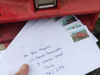 A handful of letters to MPs are posted into a red post box