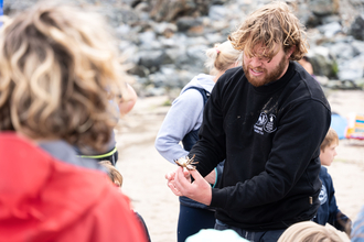 volunteer showing crab to people