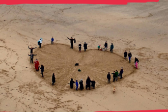 People on a beach arranged in a heart, with text reading Love Your Beach Spread love, not litter