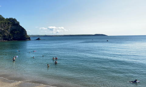 Picture shows a sunny day on the south coast of cornwall with water users enjoying the sea within st austell bay